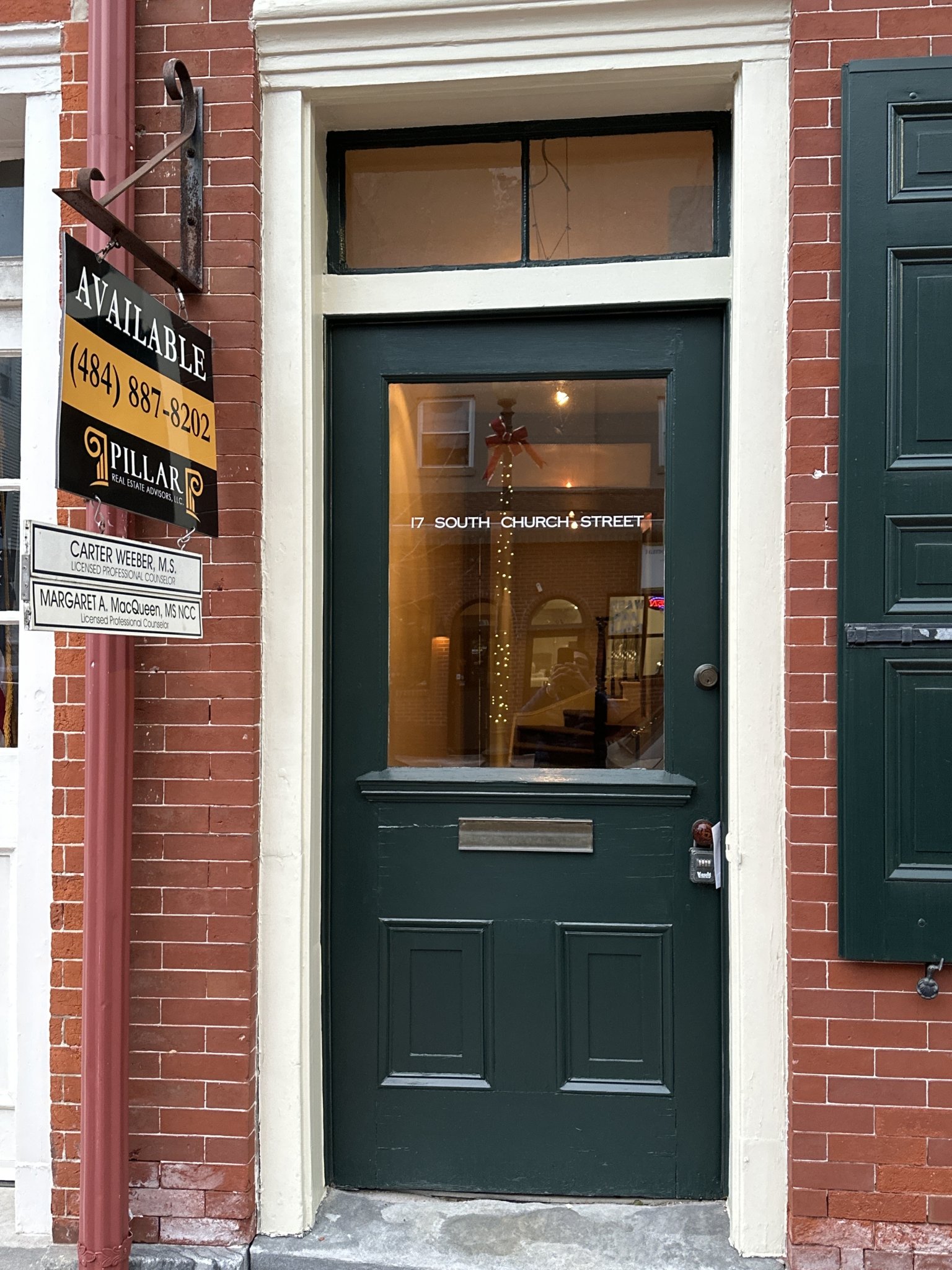 Brick office entrance with a black door – Nuance Psychiatric Services office